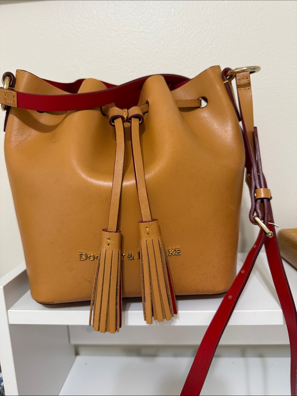 Dooney & Bourke Tan Leather Drawstring Bucket Bag with Red Trim